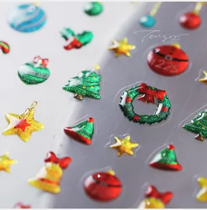 Macro detail of 3D Christmas nail stickers with glitter textures and festive elements