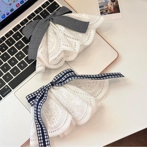 Detailed view of sweet lace bow hair clips in grey ribbon and blue checkered patterns