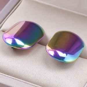 Macro shot of iridescent rainbow 304 stainless steel earrings in a luxury jewelry box