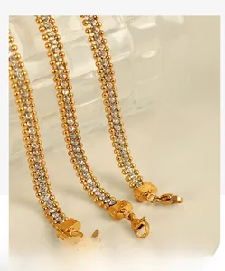 Detailed macro view of three gold-plated tennis bracelets with rows of white zircon stones