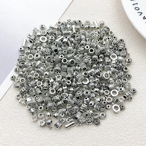 Detailed view of assorted Tibetan silver spacers and beads for DIY jewelry making