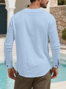 Detail view of back of men's light blue cotton linen shirt with rounded hem and buttoned cuffs