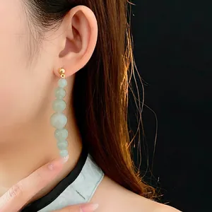 Elegant beaded drop earrings with light green aventurine stones and gold ball studs