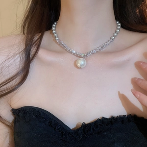 Close-up of grey pearl and crystal choker necklace with a central pearl pendant on model