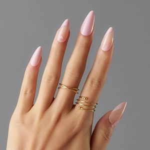 Detailed view of pink press-on nails featuring French heart tips and wave patterns
