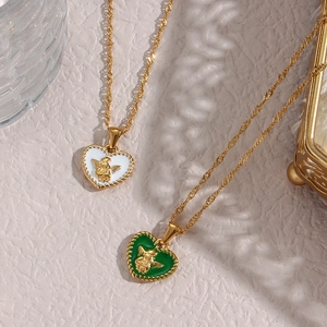 Vintage heart necklaces with white and green enamel angel pendants on gold twisted chains