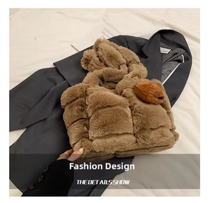 Detailed view of brown faux fur handbag with quilted texture and cute bear pendant accessory