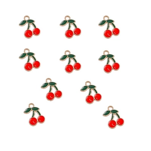 Detail of ten red alloy cherry pendants with green leaves and gold edges for DIY jewelry