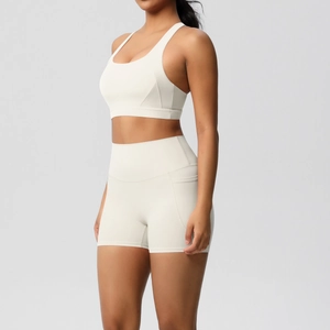Detail of ivory yoga set showing high waist shorts with side pocket and elastic fabric