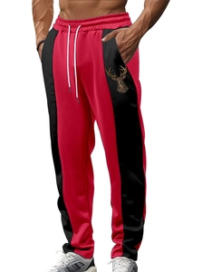 Pantaloni sportivi uomo in rosso e nero con stampa logo testa di cervo dorata