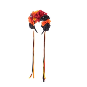 Detail of Halloween headband with red and orange fabric roses and long colored ribbons