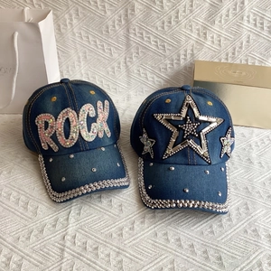 Detail of denim baseball caps with pink rhinestone ROCK letters and star patterns