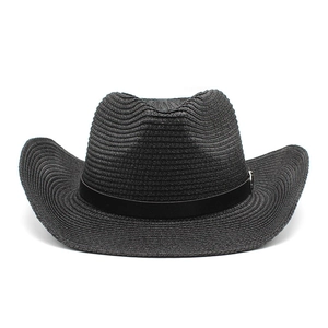 Detail of black woven straw cowboy hat featuring a textured brim and metallic buckle band
