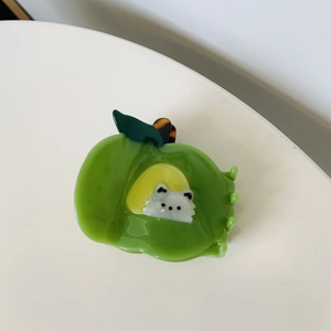 Detail of cute fruit cat claw clip in bright green and yellow acrylic finish