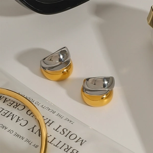 Modern two-tone gold and silver stainless steel ear cuffs with a sleek geometric arc design
