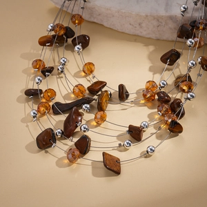 Detail of bohemian layered necklace with tiger eye stones and amber beads