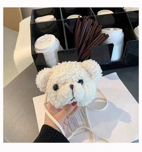 Detail of white plush teddy bear crossbody bag with soft faux fur and braided strap