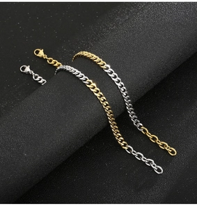Detail of two-tone gold and silver Miami Cuban link bracelet on a display stand