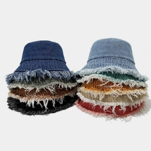 Distressed denim bucket hats with frayed edges in multiple colors for street style