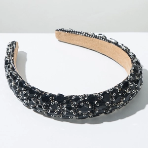 Detail of baroque black rhinestone headband featuring silver claw setting and velvet lining