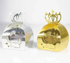 Detail view of hollow elephant candy boxes in gold and silver finish with crown handles