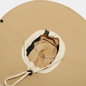 Detail of khaki sun hat with 100% polyester fabric texture and adjustable windproof cord