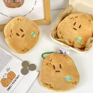 Close-up of soft plush potato coin purses with zipper and carbineer on magazine props