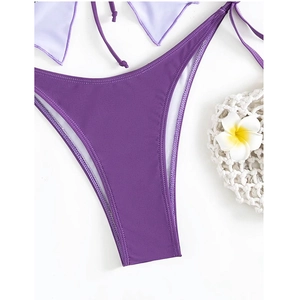 Detail of high-cut purple bikini bottoms with premium matte texture and seamless stitching