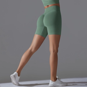 Close-up of high-waisted seamless sage green yoga shorts with scrunch butt lift detail