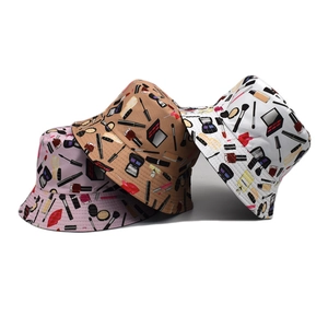 Women's reversible bucket hat with cosmetic prints in pink, khaki, and white options