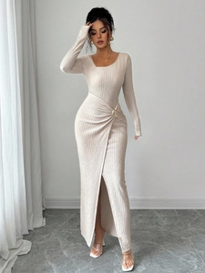 Detail of waist pleats with gold ring buckle on cream long sleeve slit maxi dress