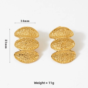 Detail of gold-tone 316 stainless steel earrings with layered oval design and hammered texture