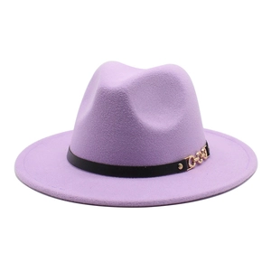 Detail of lavender wool fedora hat featuring a black leather band and gold metal chain buckle
