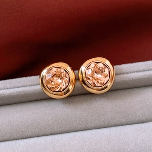 Macro shot of vintage style 18K gold plated oval earrings with champagne crystals