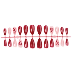 Almond shaped press-on nails featuring red and pink colors with delicate bow designs