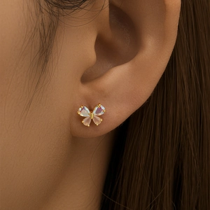 Macro shot of colorful iridescent butterfly stud earring worn on a female ear
