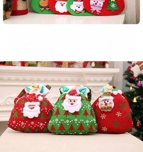 Close-up of velvet Christmas drawstring bags with Santa and Snowman appliques