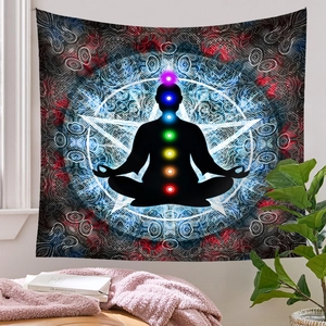 Detail of meditation tapestry featuring chakra silhouette and mandala pattern in a cozy room
