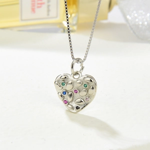 Silver heart pendant necklace with hammered texture and colorful zircon stones detail