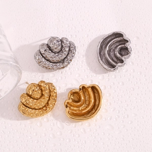 Detail view of 18K gold and silver plated triple-layered hammered texture fan earrings