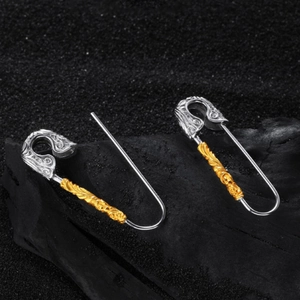Vintage safety pin earrings with engraved gold floral pattern and silver finish