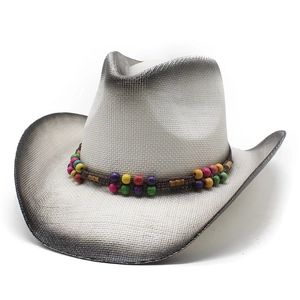Detail of western straw hat with colorful wooden beads and braided band decoration