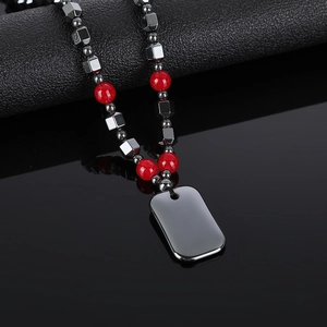 Hematite magnetic bead necklace with red agate-style stones and black dog tag pendant