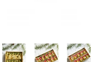 Detail of golden Christmas bell with red ribbon bow and pine cone on a pine branch
