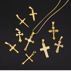 Detailed macro view of assorted 18K gold plated cross pendants with crystal accents