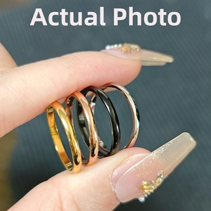 Close-up of minimalist stainless steel ring set in gold, rose gold, black, and silver