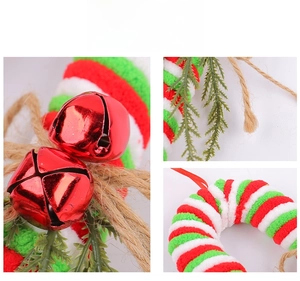 Detailed macro view of red bell, plush stripe ring, and pine needle Christmas ornament