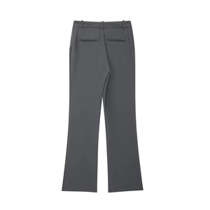 Detail view of dark grey suit trousers showing back pockets and smooth fabric drape