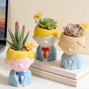 Three boy-shaped resin planters with colorful suits holding succulents and dried flowers