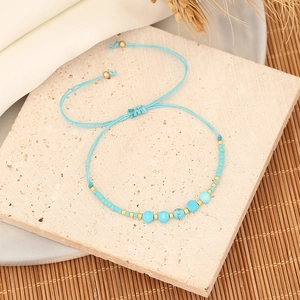 Handmade bohemian beaded bracelet with sky blue woven cord and natural turquoise accents
